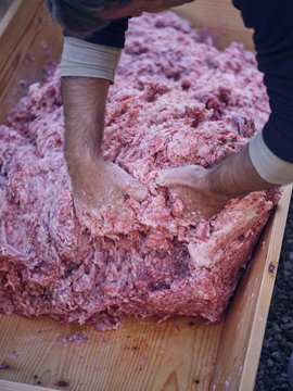 Crop hands mixing minced meat