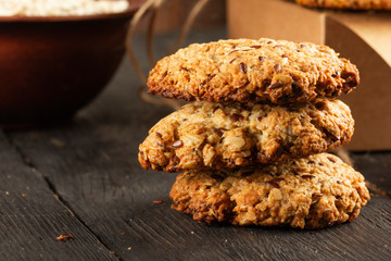 Oatmeal cookies with milk on tray on rustic wooden table