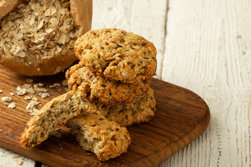 Oatmeal cookies with milk on tray on rustic wooden table