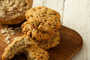 Oatmeal cookies with milk on tray on rustic wooden table