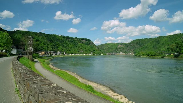 Cargo ship. Loreley Rock at the Rhine River  with the City St. Goar in the background, region Rhineland-Palatinate, Germany St. Goar, Central Europe, july 2017