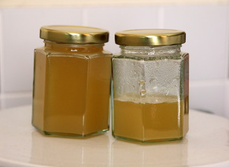 Jar of honey on white background in kitchen