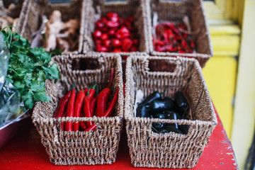 Fototapeta na wymiar A market stand with wicker baskets full of seasonal vegetables