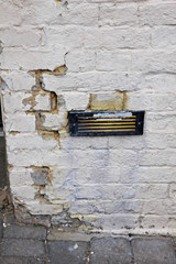 Old Vent in Cracked Brick Wall