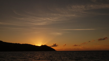 Sunset behind an island in the Indian ocean 