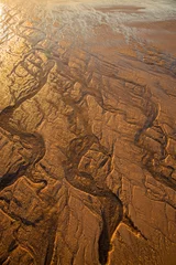 Gordijnen Western Australia – sandy beach at low tide with water channels as closeup in the morning sun © HLPhoto