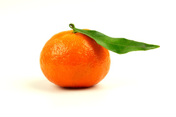 Ripe tangerine on a white background with a green leaf