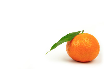 Ripe tangerine with a green leaf on a white background