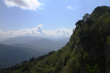 Fototapeta na wymiar Photo of nature - fantastic petrous mountain slope with light blue sky