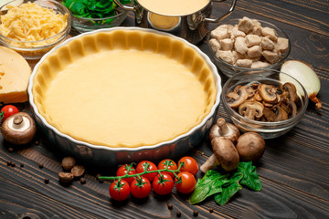 shortbread dough for baking quiche tart in baking form and ingredients