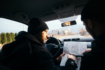 Bank robbers,planning their next hit while holding a gun and counting on a stop watch the time they...