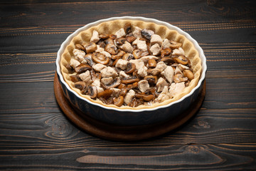 shortbread dough for baking quiche tart and filling in baking form