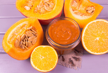 Homemade preserves. Pumpkin jam on a wooden background.