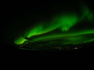 Winter scenic landscape night view of  Aurora Borealis/Northern lights dancing on the clear sky full of stars above lake Myvatn, north Iceland Beautiful winter wonderland/fairytale background scene. 