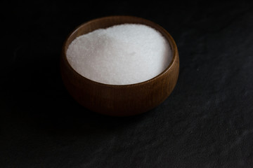 Salt in Cup made of wood with spoon  
