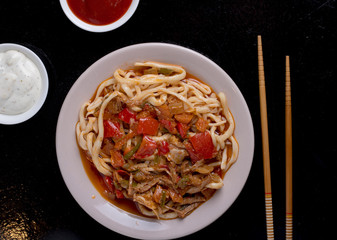 vegetables spaghetti and meat with two food sticks, top view