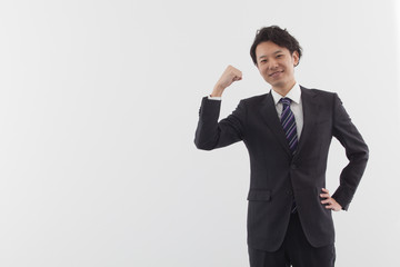A young Asian business man standing with energy