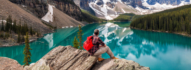 Hiking Man Looking at Moraine Lake & Rocky Mountains Panorama