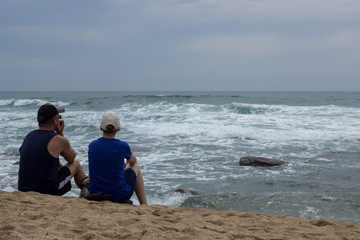 Fototapeta premium elderly couple sitting on the beach enjoying the sea view 
