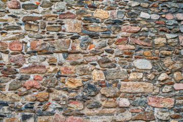 Naklejka premium stone old stone church wall as backgroundwall,