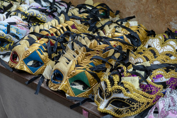 The masks of the Venice carnival hung in a shop. Venetian masks representing the carnival.