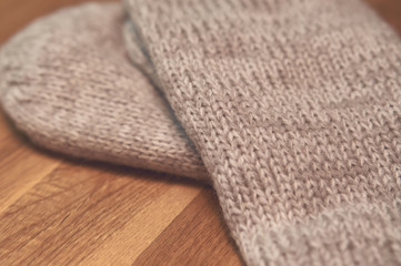 A pair of mittens on wooden table