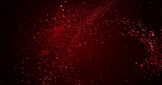 christmas red gradient sparkle glitter explosion dust particles from top on black background with bokeh flowing movement, holiday happy new year and valentine day love, relationship
