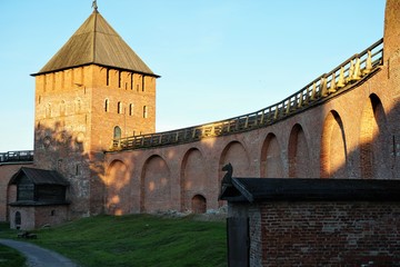 Fototapeta premium Veliky Novgorod, Russia, May 2018. View of the fortress wall and watchtower at sunset from inside the Kremlin.
