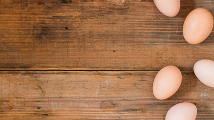 Easter eggs on old wooden background. Horizontal banner.