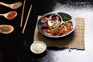 asian food, ready meal to eat in lunch box with sticks and sauce