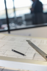 Close-up of a drawing, ruler and a pencil on the table of an off