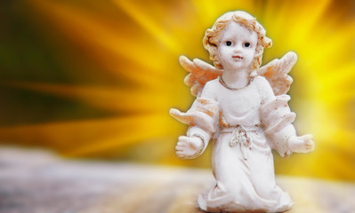 Ancient stone statue of  little angel as symbol of guard for children. Love, faith, hope, religion, Christianity, good concept.