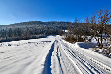 Fototapeta na wymiar Snow road at winter sunny day