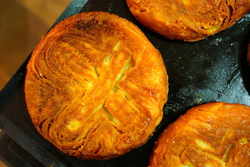 View of a Kouign-amann, a traditional Breton cake made with butter - obrazy, fototapety, plakaty