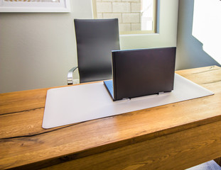 Black Laptop Computer On Empty Desk