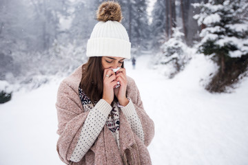 Woman suffering from cold,using handkerchief