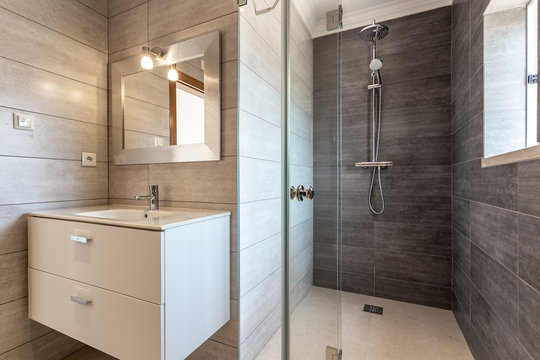 Modern bathroom with shower and washbasin for hygiene.