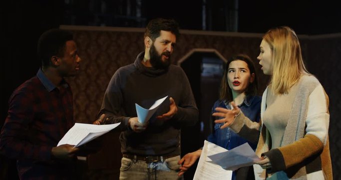 Medium shot of actors and actresses arguing during rehearsal in a theater