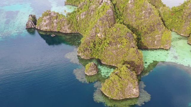 Aerial View of Coral Reefs Surrounding Limestone Islands in Raja Ampat
