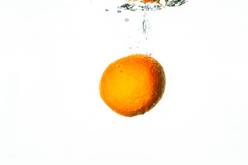 Fresh fruit falls into water with white background