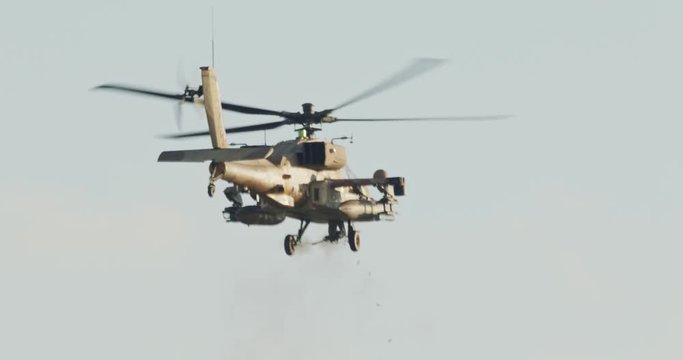 AH-64D Apache Longbow military helicopter attacking targets with canon