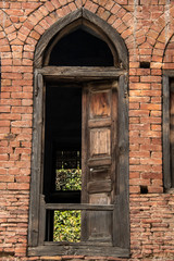 Fototapeta na wymiar Ancient door frames and windows which is in requirement of major repair inside Jallianwalla bagh memorial