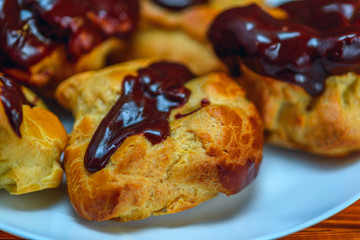 chocolate eclairs on a wooden background