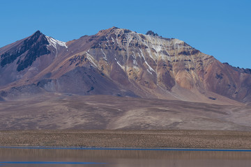 Snow capped peaks and rugged landscape of the altiplano, around 4000 metres above sea level, in...
