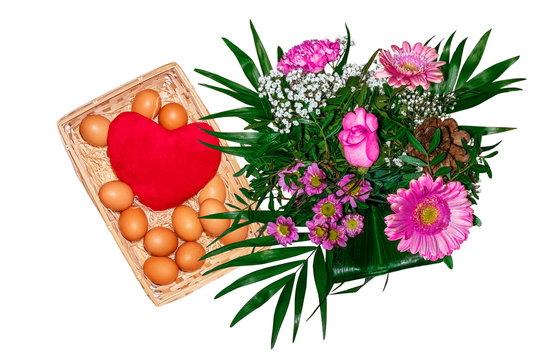 Bouquer of flowers and basket with eggs and heart in white background.