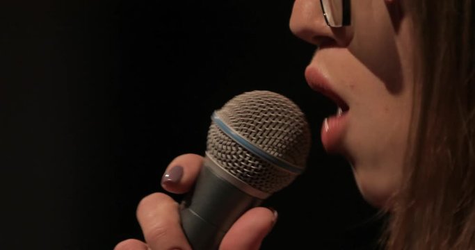 Singer and microphone, closeup portrait, lips