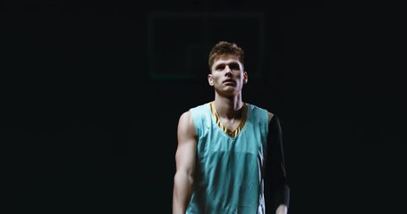 Portrait of determined high school team basketball player practicing shots indoors. 4K UHD