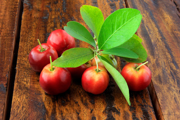Acerola Cherry raw, fresh, on rustic wooden table, High vitamin C and antioxidant fruits