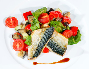 Mackerel baked with lemon, cherry tomatoes, vegetables and spices.