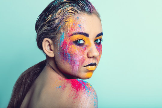 Young pretty girl with colorful creative make-up, studio shoot .
